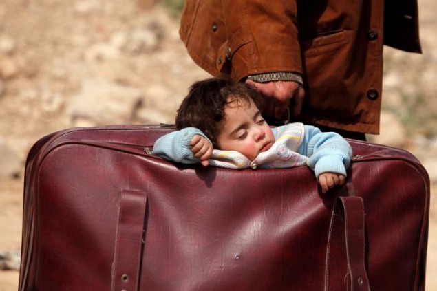 Foto:  REUTERS / Omar Sanadiki, Dieťa spiace v taške v dedinke Beit Sawa, Sýria