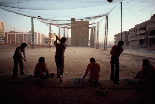 A temporary vacant lot serves as driving range amid high rise buildings, December 1979. PHOTOGRAPH BY H. EDWARD KIM, NATIONAL GEOGRAPHIC