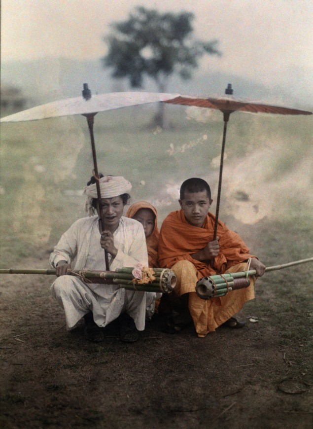 Shan man and two priests prepare to set off bamboo rockets in rain, Myanmar, November 1931. PHOTOGRAPH BY W. ROBERT MOORE, NATIONAL GEOGRAPHIC
