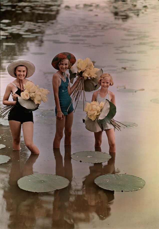 Girls standing in water holding bunches of American Lotus, Amana, Iowa, November 1938. PHOTOGRAPH BY J. BAYLOR ROBERTS, NATIONAL GEOGRAPHIC