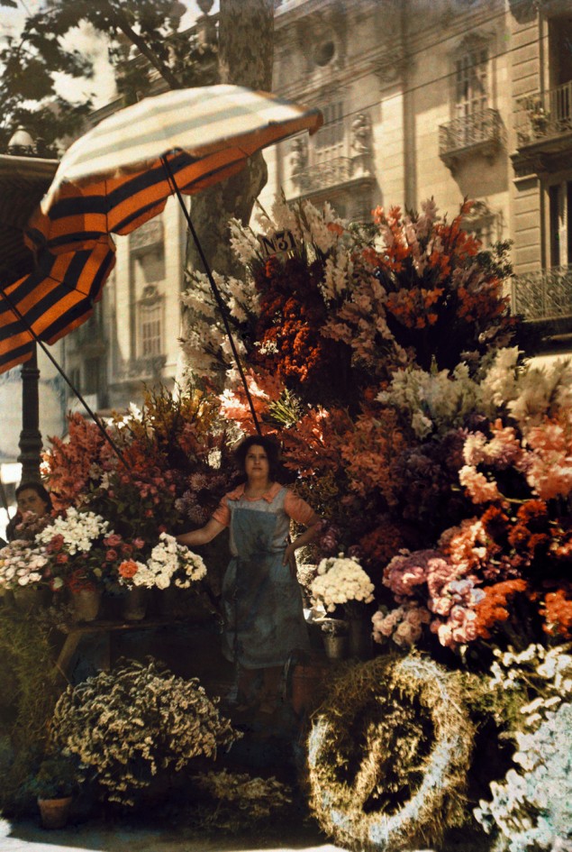 A woman stands in front of her flower stand on the Rambla in Barcelona, Spain, March 1929. PHOTOGRAPH BY JULES GERVAIS COURTELLEMONT, NATIONAL GEOGRAPHIC