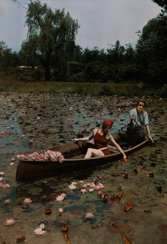 A couple in a boat paddle on a lily pond and collect flowers in the Kenilworth Aquatic Gardens in Washington D.C., 1923. PHOTOGRAPH BY CHARLES MARTIN, NATIONAL GEOGRAPHIC