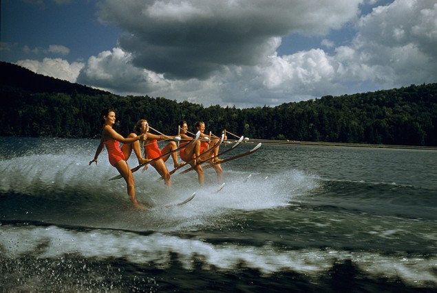 A women’s water ski team lifts skis while being towed at 23 mph on Darts Lake in New York, 1956. PHOTOGRAPH BY ROBERT SISSON, NATIONAL GEOGRAPHIC CREATIVE
