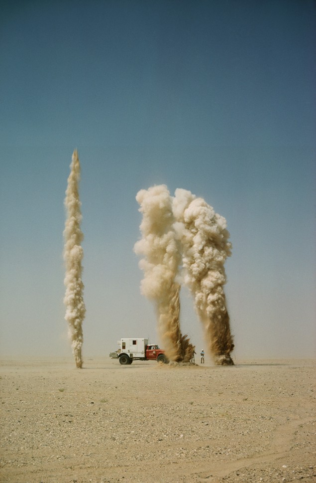 Geysers of sand explode as geologists probe for oil-bearing land in Saudi Arabia, January 1966. PHOTOGRAPH BY THOMAS J. ABERCROMBIE, NATIONAL GEOGRAPHIC