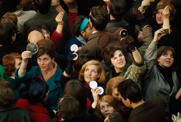 Women use compact mirrors in packed crowd to catch sight of the queen in London, June 1966. PHOTOGRAPH BY JAMES P. BLAIR, NATIONAL GEOGRAPHIC