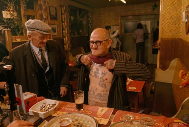 A man shows off his tattoos in a pub in Boston, England in 1974. PHOTOGRAPH BY JAMES L. AMOS, NATIONAL GEOGRAPHIC